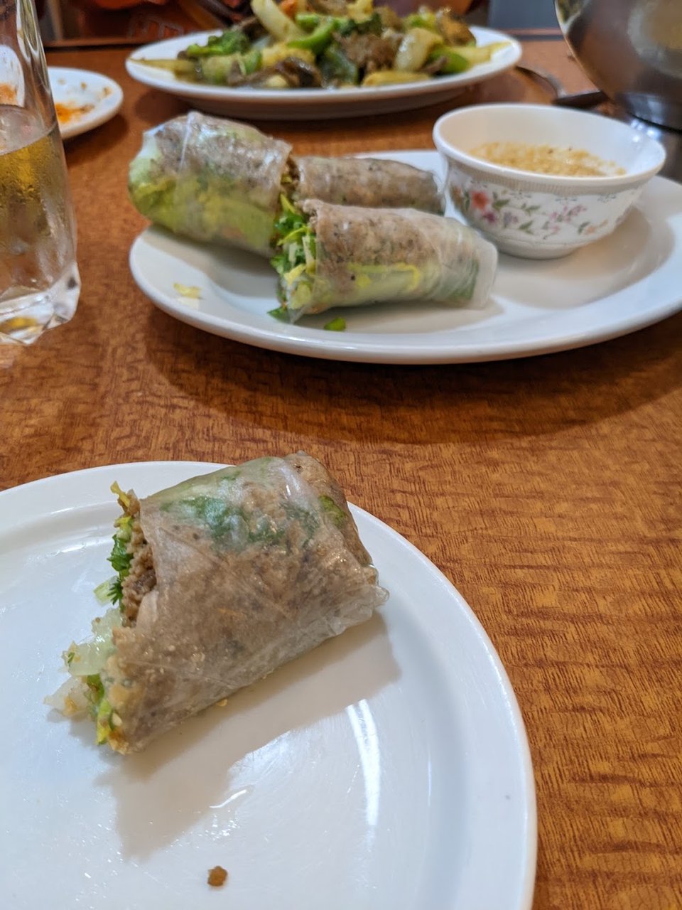 Drink list beside Cambodian dishes and small plates.