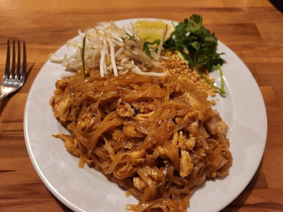 Drink list beside Cambodian dishes and small plates.