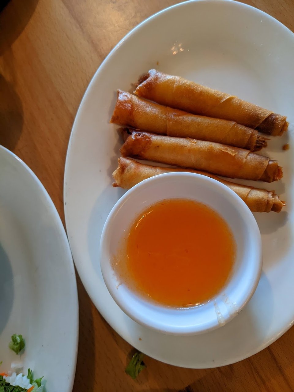 Drink list beside Cambodian dishes and small plates.